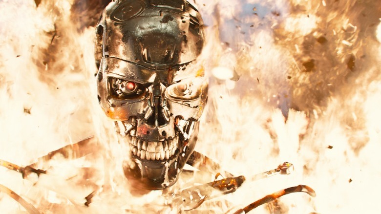 A metallic T-1000 walking through fire