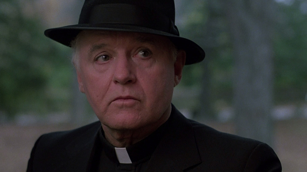 Father Delaney wearing a hat