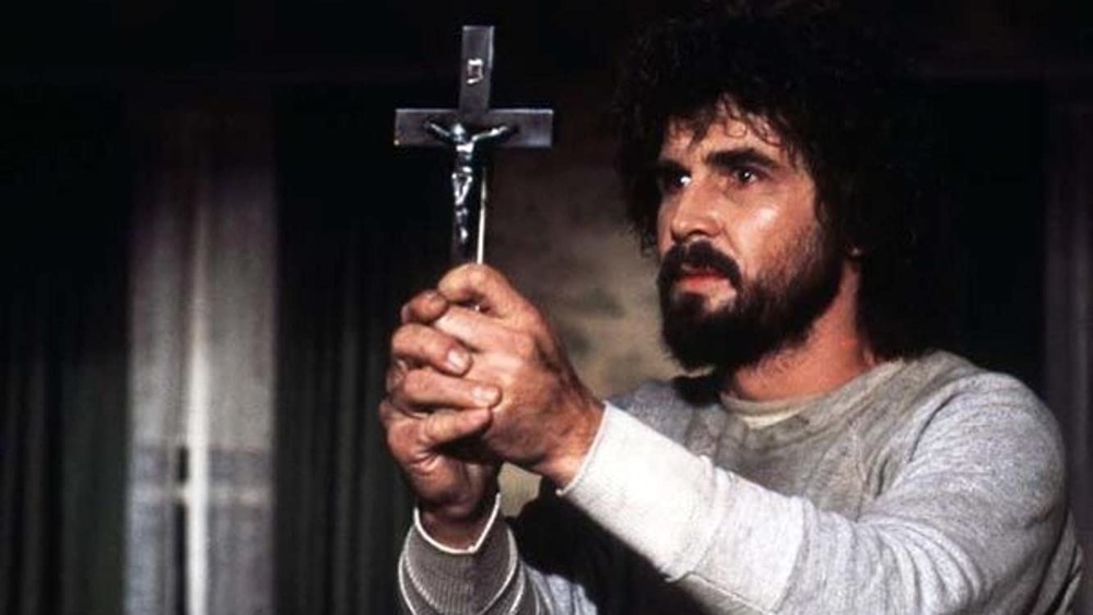 George holding a crucifix