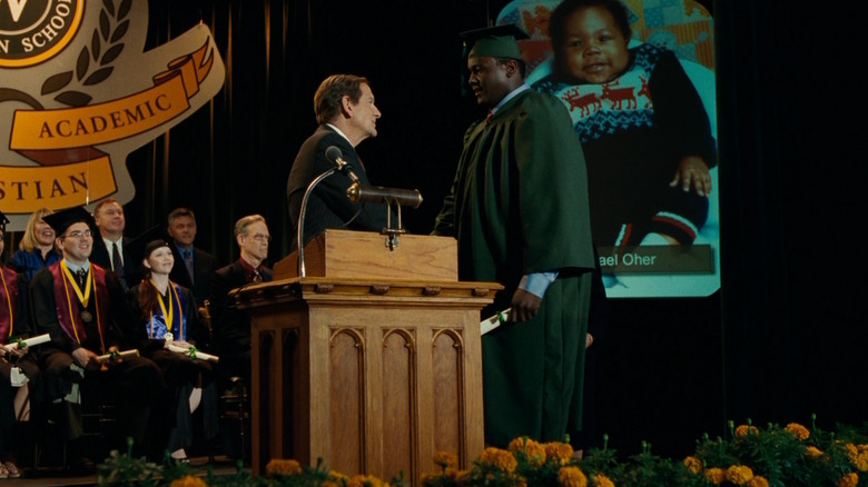 Michael accepts his diploma