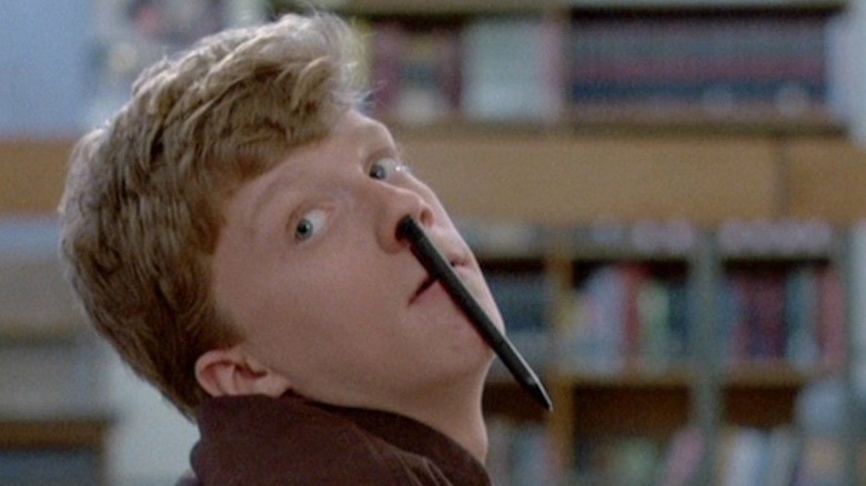 Brian with a pen up his nose in The Breakfast Club 