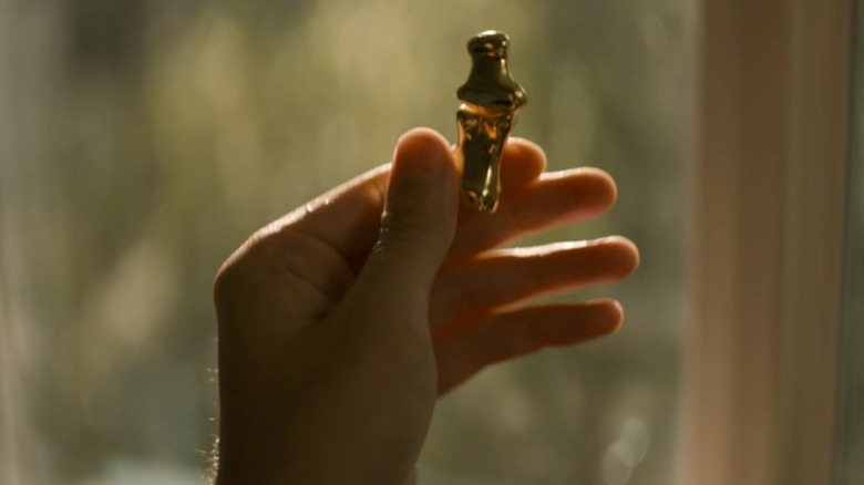 A hand holding golden bones