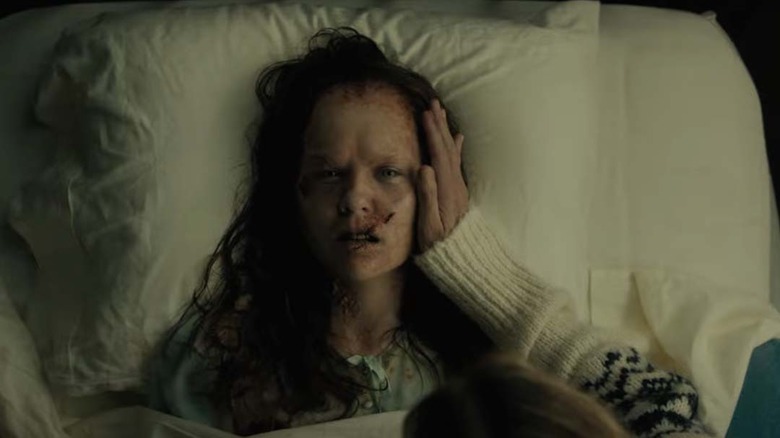 Katherine sitting in bed while possessed