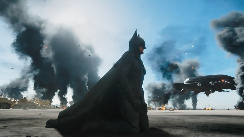 Batman kneeling on smoking battlefield