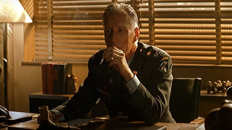 Moore smoking at his desk in The General's Daughter