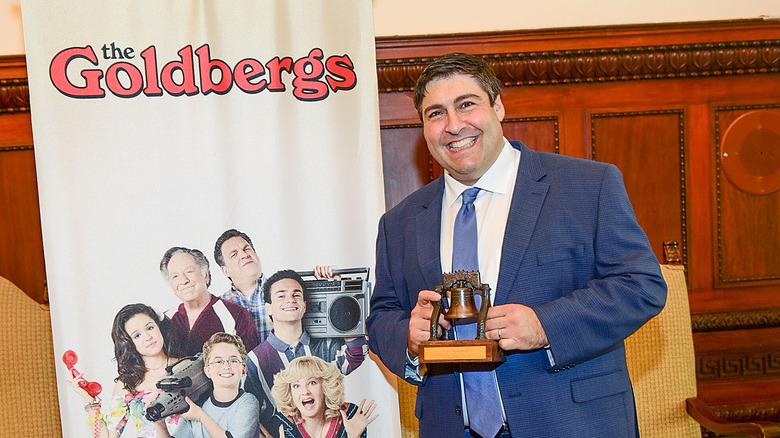 Adam F Goldberg holding award