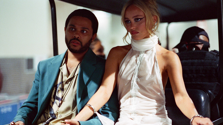 Tedros and Jocelyn riding a golf cart