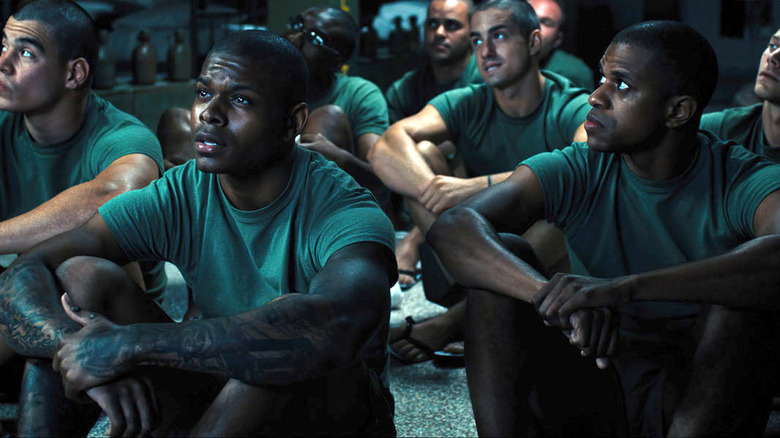 Marine recruits sitting on floor