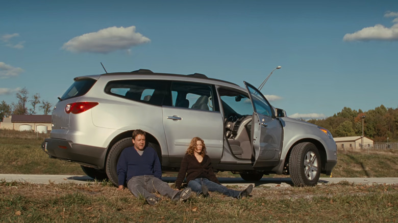 couple sitting outside car