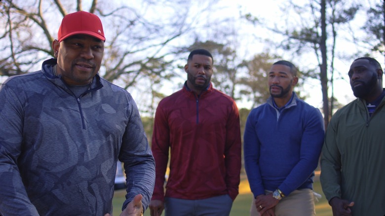 Maurice standing on golf course with friends