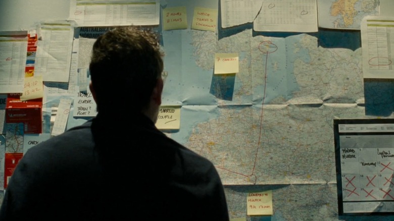 Jacob looking at case board in "The Postcard Killings" (2020)