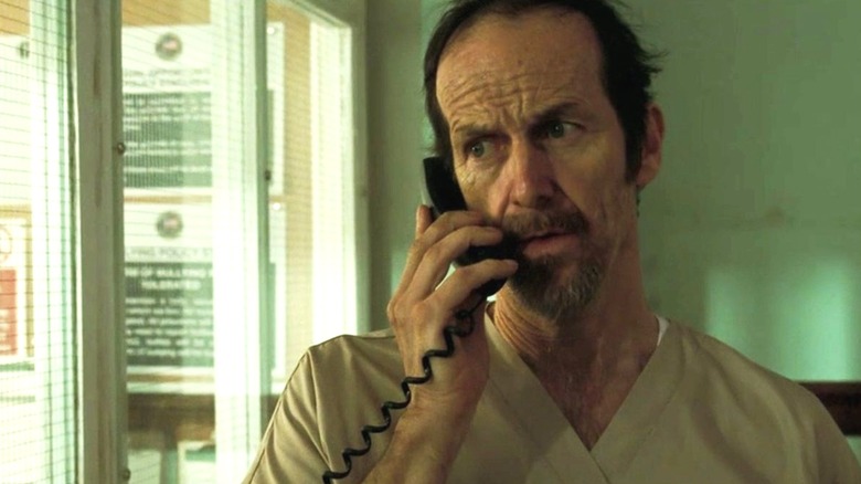 Mr. Haysmith talking on the phone in "The Postcard Killings" (2020)