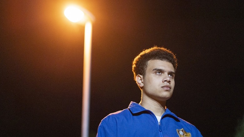 Sebastian standing under street lamp