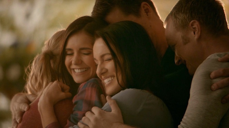 Elena and her family hug