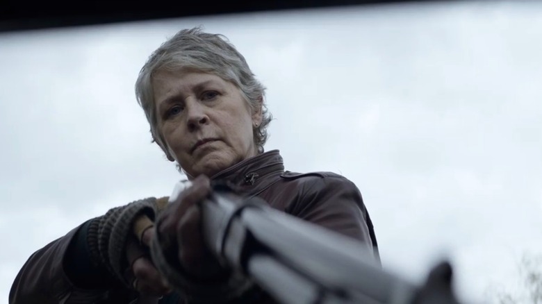 Carol holding a shotgun