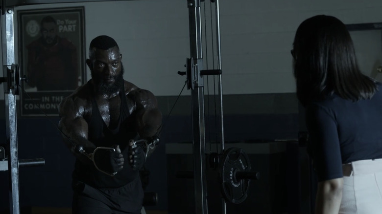 Mercer working out in front of poster