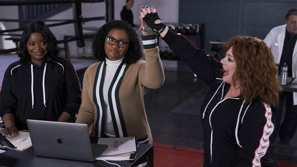 Lydia high-fiving Tracy with Emily smiling