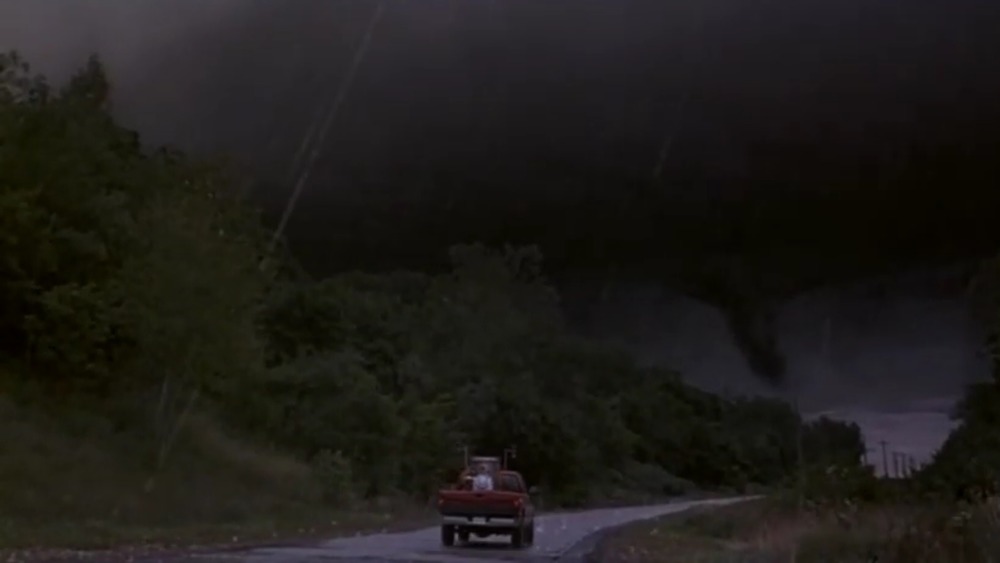 Truck driving toward tornado