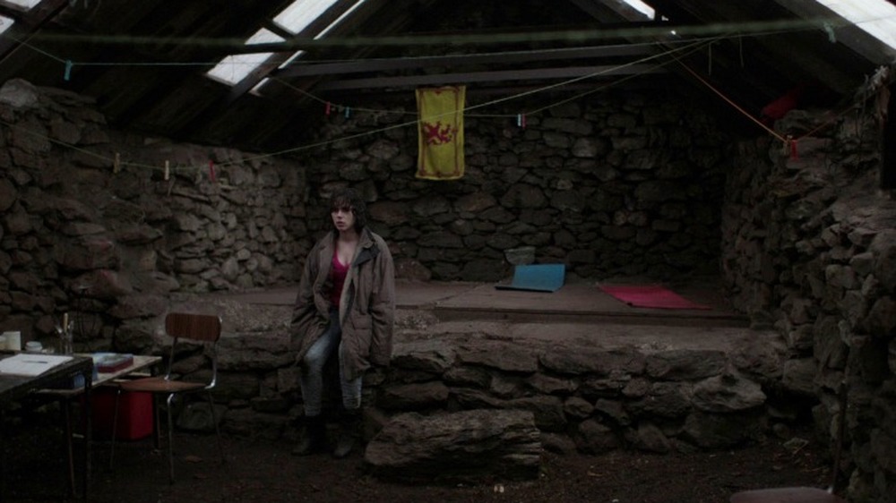 The Female standing inside a cabin