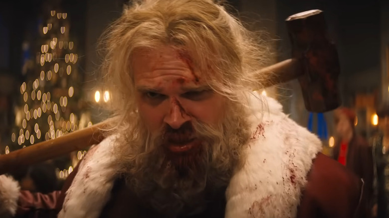 David Harbour as Santa holding hammer