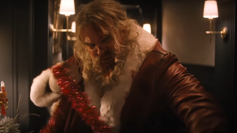 David Harbour as Santa holding tinsel