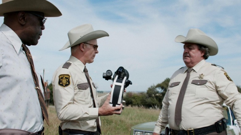 Police officers holding camera