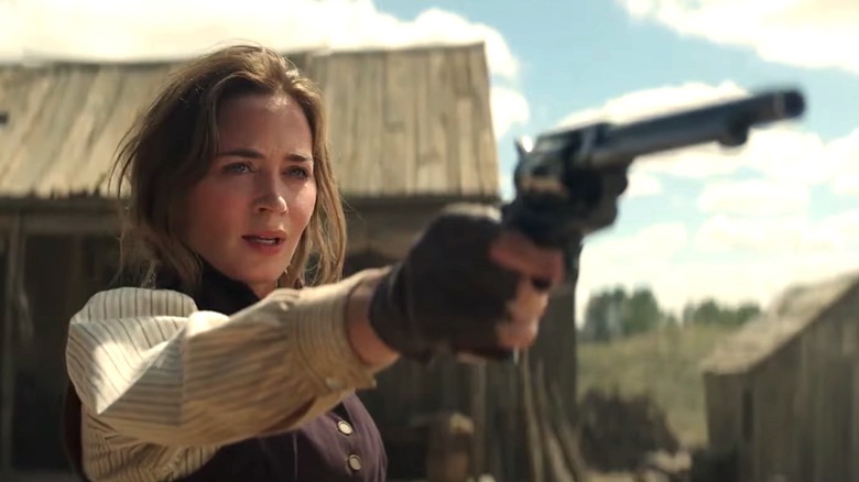 Emily Blunt pointing a gun