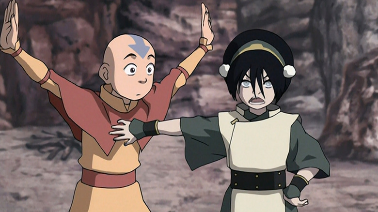 Toph holding Aang off