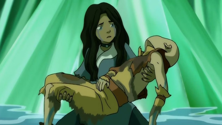 Katara crying and holding Aang
