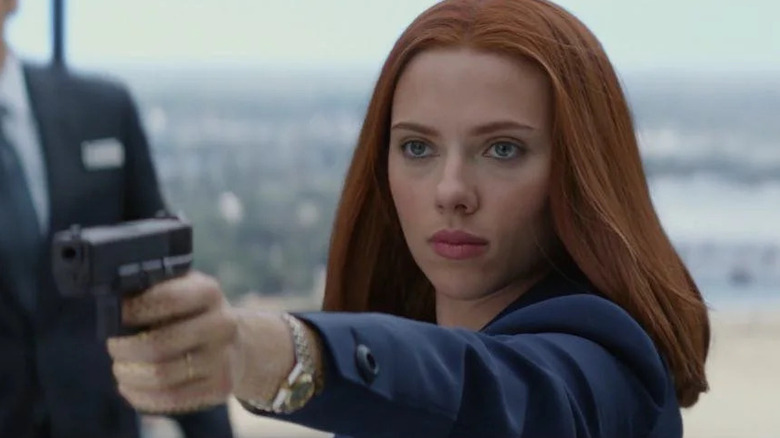 Romanoff points a gun