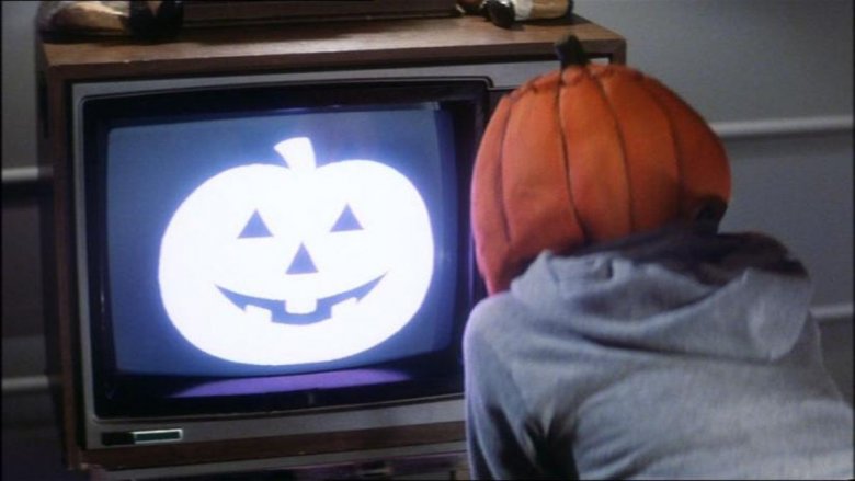 pumpkin mask kid watching TV