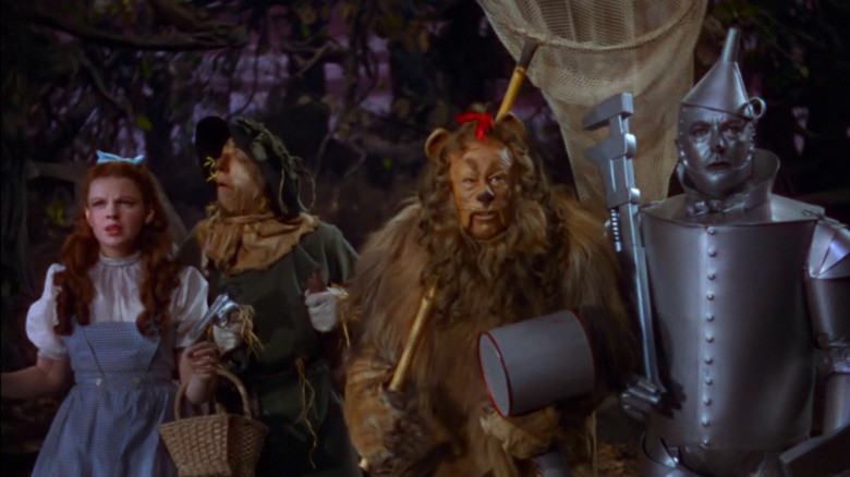 Dorothy, Tin Man, Scarecrow and the Lion in a row