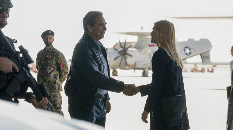 President Warner shaking Carrie Mathison's hand