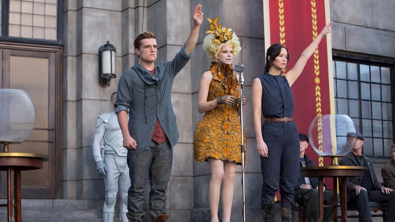 Katniss, Peeta, and Effie on stage