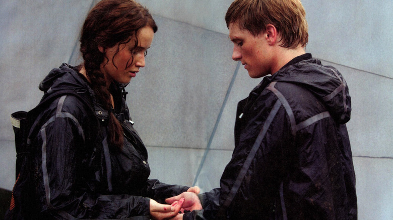 Katniss and Peeta hold berries