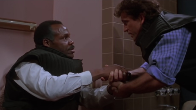 Murtaugh and Riggs in a bathroom