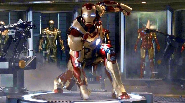 Various Iron Man suits in Tony Stark's workshop