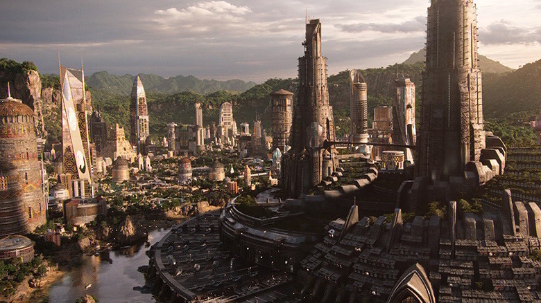 A Wakanda cityscape with futuristic buildings and lush mountains beyond