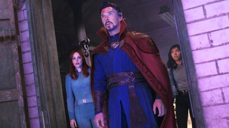 Doctor Strange, America, and Christine bathed in purple light