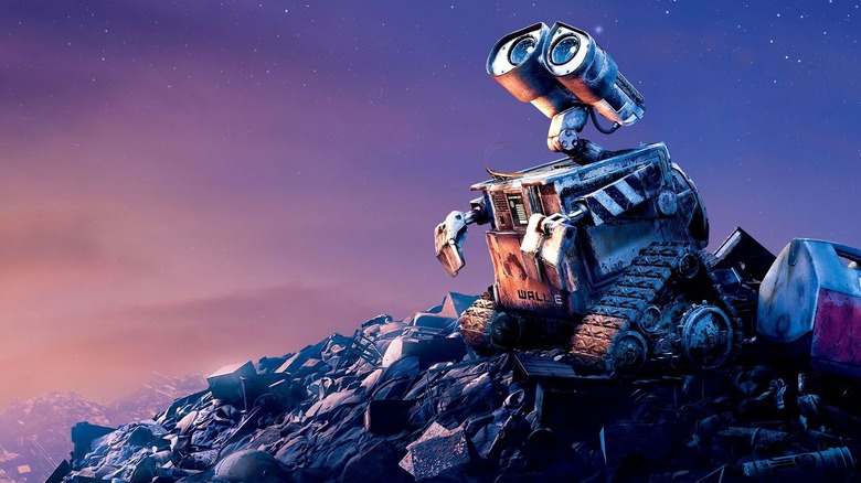 WALL-E sitting on mound of trash looking at sky