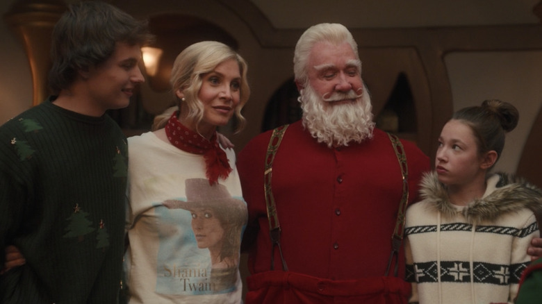 Santa hugs his family