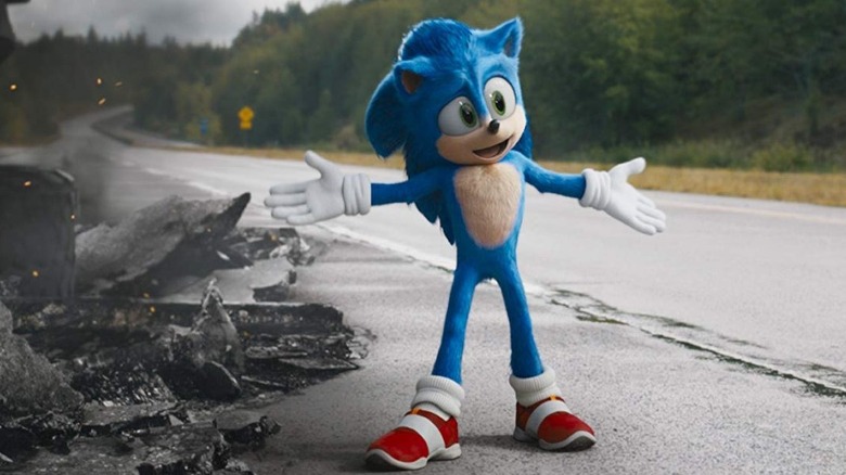 Sonic celebrates in the road near a pile of rubble in "Sonic the Hedgehog" (2020)