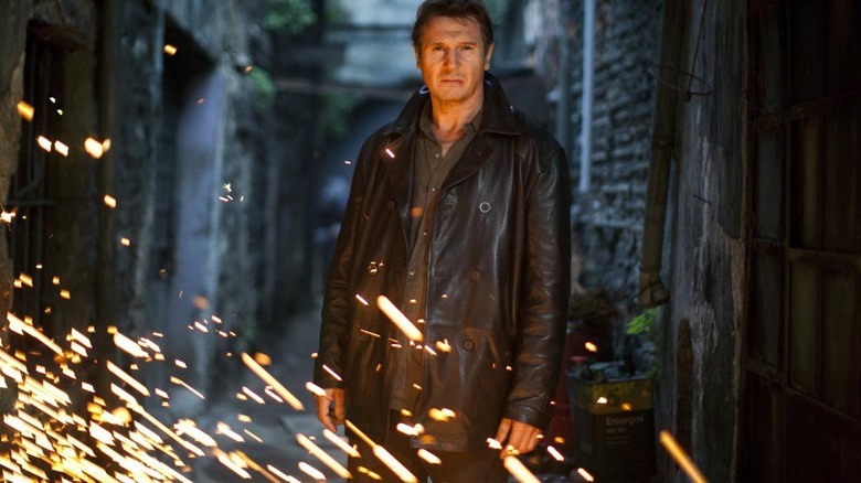 Liam Neeson in front of fire