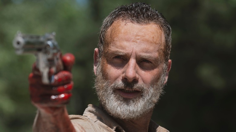 Rick with gun and bloody hand