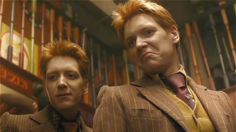 Fred and George in their prank shop, making faces