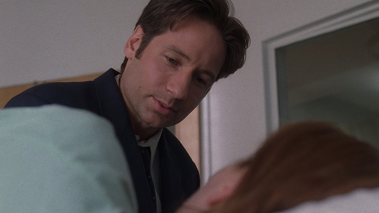 Mulder looks at bed-ridden Scully