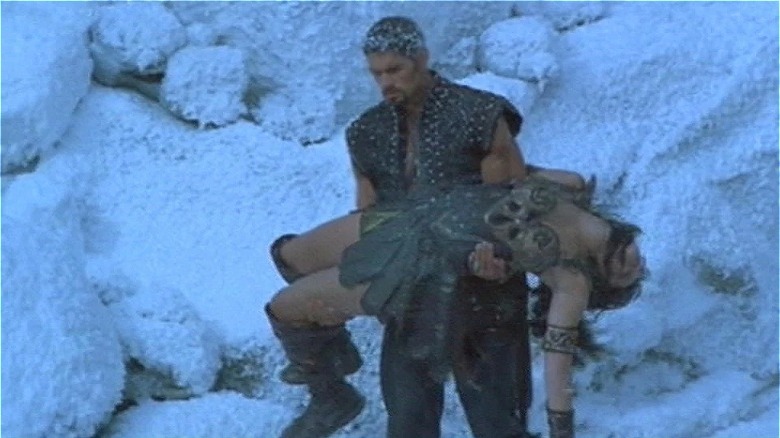 Ares carries Xena's body