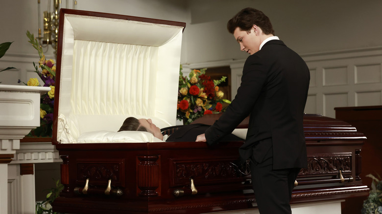 Georgie mourns at George's casket