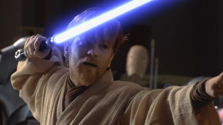 Obi-Wan Kenobi wields a lightsaber