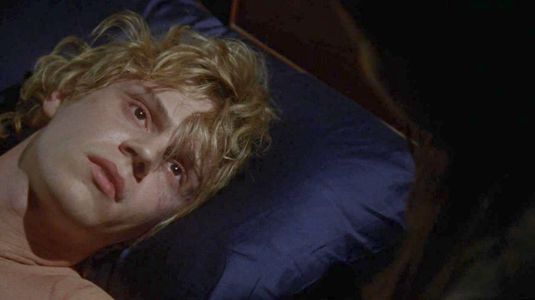 AHS Coven Kyle looking up from bed